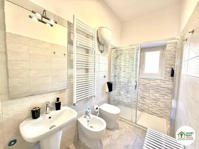 a bathroom with a sink and a toilet and a shower at Santa Maria Maggiore - Vittorio Emanuele House in Rome