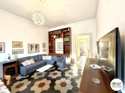 a living room with a blue couch and a fireplace at Santa Maria Maggiore - Vittorio Emanuele House in Rome