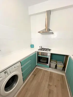a kitchen with a washing machine and a stove at La mia casetta a Roma Montesacro in Rome