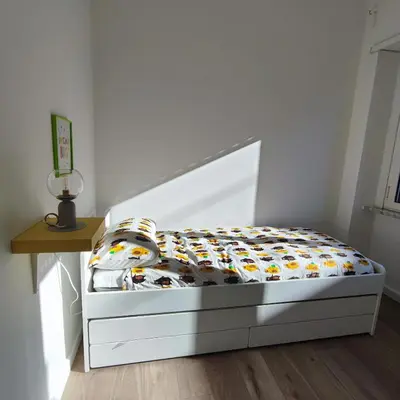 a small bed in a room with a bed frame at La mia casetta a Roma Montesacro in Rome