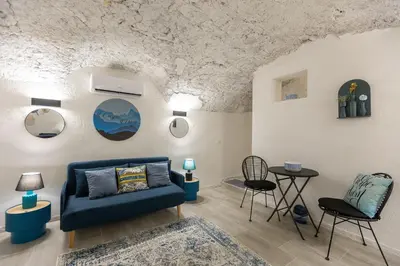 a living room with a blue couch and chairs at Carpe Diem by Rental in Rome in Rome