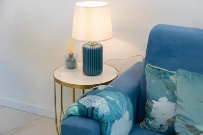 a blue chair sitting next to a table with a lamp at Carpe Diem by Rental in Rome in Rome