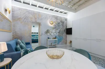 a living room with a white table and a blue couch at Carpe Diem by Rental in Rome in Rome