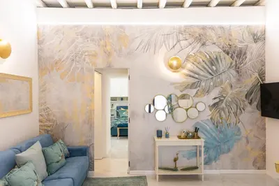 a living room with a blue couch and a mural at Carpe Diem by Rental in Rome in Rome