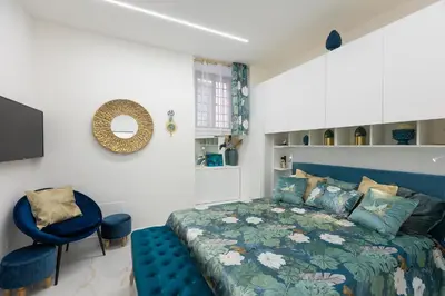 a bedroom with a blue bed and a blue chair at Carpe Diem by Rental in Rome in Rome