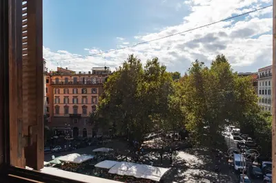 a view from a window of a street with trees at Manara 29 - FromHometoRome in Rome