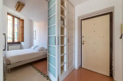 a bedroom with a bed and a closet with a door at Manara 29 - FromHometoRome in Rome