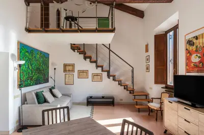 a living room with a staircase and a couch at Manara 29 - FromHometoRome in Rome