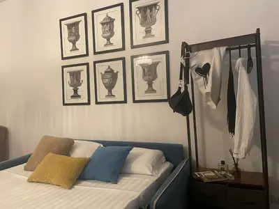 a bedroom with a bed and some pictures on the wall at Apartment Luxury Navona in Rome