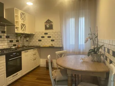 a kitchen with a wooden table and a dining room at Apartment Luxury Navona in Rome