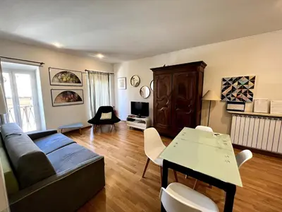 a living room with a couch and a table at Campo dei fiori - cozy and central apt in Rome