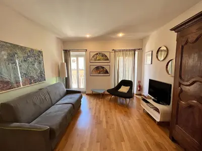 a living room with a couch and a television at Campo dei fiori - cozy and central apt in Rome