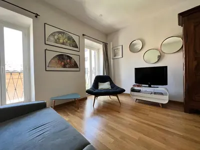 a living room with a television and a chair at Campo dei fiori - cozy and central apt in Rome