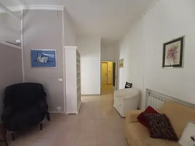 a living room with a couch and a chair at Caffarella Apartment in Rome