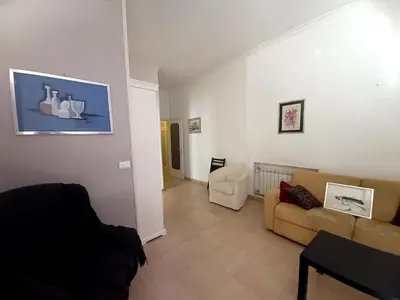 a living room with a couch and a chair at Caffarella Apartment in Rome