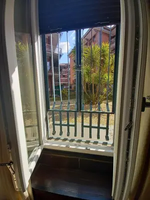an open window with a view of a courtyard at Caffarella Apartment in Rome