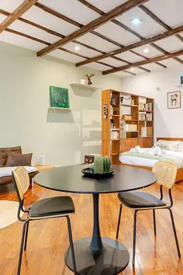 a small bedroom with a bed with a wooden ladder at Rione Monty Balcony Studio in Rome
