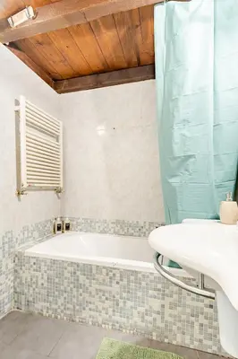 a kitchen with white cabinets and a sink at Rione Monty Balcony Studio in Rome