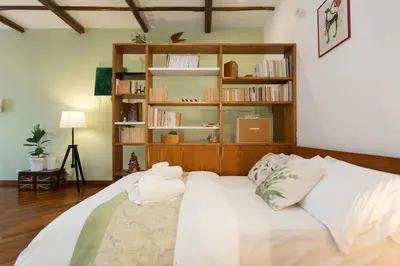a bedroom with a bed and a kitchen in a room at Rione Monty Balcony Studio in Rome