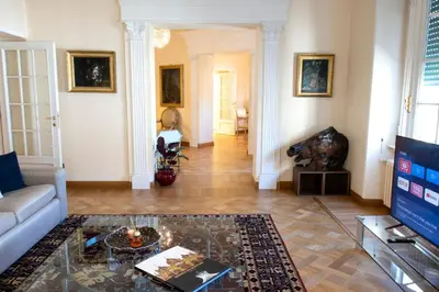 a living room with a couch and a glass table at Moon Cove, Villa Borghese Prestige Hideaway Rome in Rome