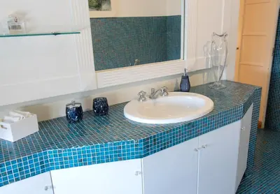 a bathroom counter with a sink and a mirror at Moon Cove, Villa Borghese Prestige Hideaway Rome in Rome