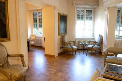 a room with chairs and a table and windows at Moon Cove, Villa Borghese Prestige Hideaway Rome in Rome