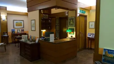 a hotel lobby with a reception counter and a desk at Hotel Benedetto in Rome