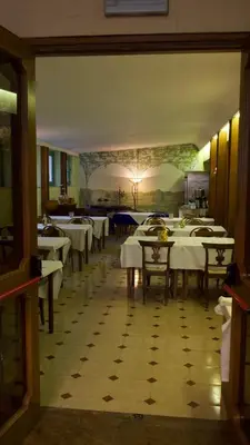 a dining room with white tables and chairs at Hotel Benedetto in Rome