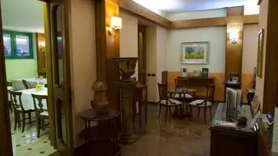 a restaurant with a dining room with a table and chairs at Hotel Benedetto in Rome