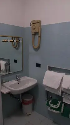 a bathroom with a sink and a mirror at Hotel Benedetto in Rome