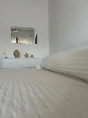 a bedroom with a white bed and a mirror at La Camilla in Rome