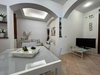 a living room with a table and a tv at La Camilla in Rome