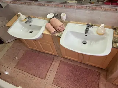 a bathroom with two sinks and two mirrors at La Camilla in Rome