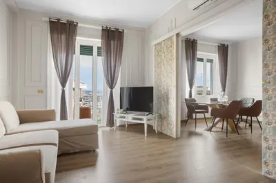a living room with a couch and a table at Maison G - new design apartment with balcony in Rome