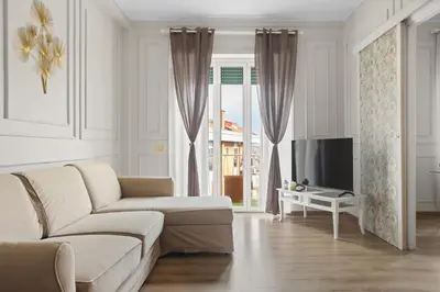 a living room with a couch and a tv at Maison G - new design apartment with balcony in Rome