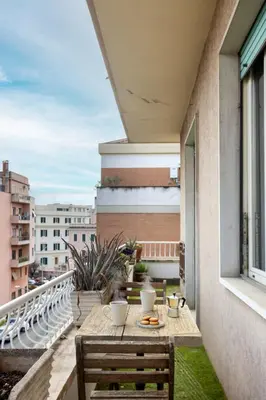 a balcony with a table and chairs on a building at Maison G - new design apartment with balcony in Rome