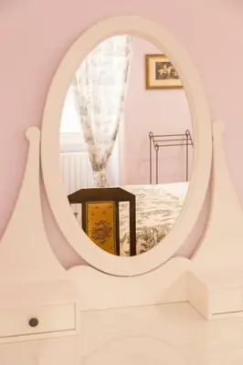 a round mirror in a white room with a bed at Arcudi Romance Home in Rome