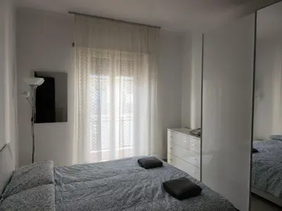 a bedroom with a bed and a dresser and a window at P7 Casa Roma in Rome