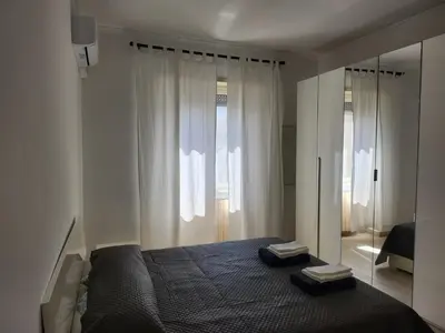 a bedroom with a bed and a mirror at P7 Casa Roma in Rome