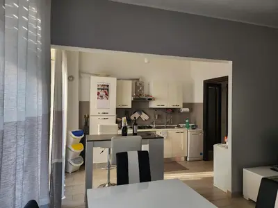 a kitchen with white cabinets and a counter top at P7 Casa Roma in Rome