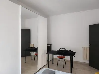 a room with two tables and a mirror at P7 Casa Roma in Rome
