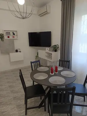 a dining room with a table and chairs and a television at CASA NONNO - Casa Vacanze in Rome