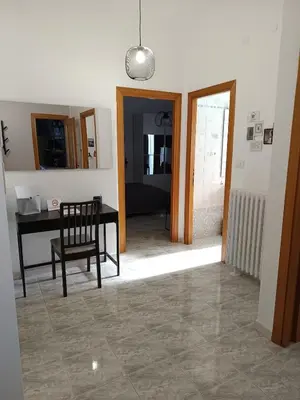 a room with a table and a chair and a desk at CASA NONNO - Casa Vacanze in Rome