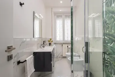 a white bathroom with a sink and a toilet at Casa di Gina in Rome