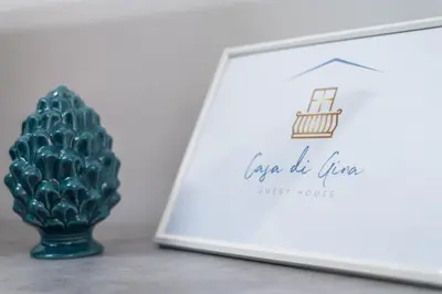 a picture of a green vase next to a book at Casa di Gina in Rome