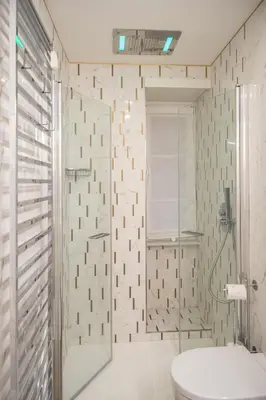 a bathroom with a toilet and a glass shower at Enjoy Colosseum Apartment in Rome