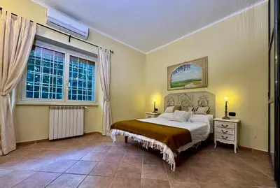 a bedroom with a bed and a window at Via Arese Apartment in Rome
