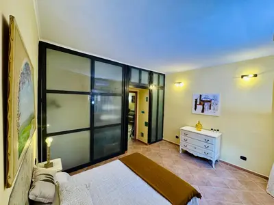a bedroom with a bed and a dresser and a window at Via Arese Apartment in Rome