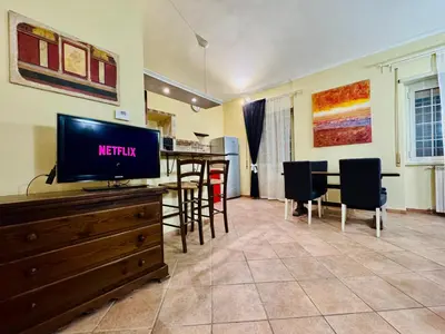 a living room with a television on a dresser at Via Arese Apartment in Rome