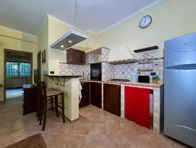 a kitchen with a refrigerator and a counter top at Via Arese Apartment in Rome
